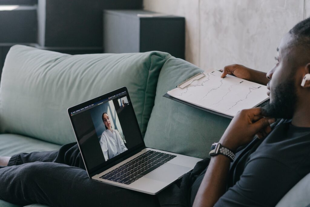 person in black long sleeve shirt using macbook pro